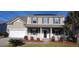 Two story house with a front porch and solar panels at 1450 Coopers Hawk Dr, Hanahan, SC 29410