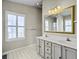 Bathroom with double vanity, tiled floor, and a large mirror at 1505 Sweet Myrtle Cir, Mount Pleasant, SC 29466