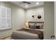 Bedroom with hardwood floors, window with shutters and a queen bed at 4252 Faber Place Dr # 203, North Charleston, SC 29405