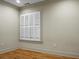 Empty bedroom with hardwood floors and window with shutters at 4252 Faber Place Dr # 203, North Charleston, SC 29405