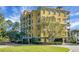 Yellow condo building with parking and landscaping at 4252 Faber Place Dr # 203, North Charleston, SC 29405