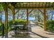 Wooden gazebo with table and chairs overlooking a wooden pier at 4252 Faber Place Dr # 203, North Charleston, SC 29405