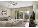Main bedroom with hardwood floors, access to balcony and ceiling fan at 4252 Faber Place Dr # 203, North Charleston, SC 29405