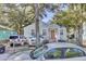 Charming light blue house with orange door and mature trees at 2748 E Surrey Dr, North Charleston, SC 29405