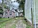 Backyard view of dilapidated houses and unkempt grounds at 11 Allway St # B, Charleston, SC 29403