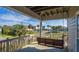 Relaxing covered porch with swing overlooking a neighborhood street at 202 Mary St, Edisto Island, SC 29438