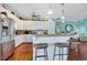 Open kitchen with island and white cabinetry at 202 Mary St, Edisto Island, SC 29438