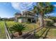 Two-story home with multiple decks, surrounded by lush landscaping and a fence at 202 Mary St, Edisto Island, SC 29438