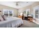 Spacious primary bedroom with king-size bed, ample windows, and a TV at 202 Mary St, Edisto Island, SC 29438