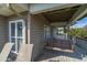 Covered deck with a wooden swing, offering shaded outdoor seating at 202 Mary St, Edisto Island, SC 29438