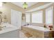 Large bathroom with soaking tub, double vanity, and tile flooring at 202 Mary St, Edisto Island, SC 29438