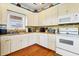 Corner kitchen with white cabinets and stainless steel appliances at 202 Mary St, Edisto Island, SC 29438