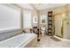 Bathroom with soaking tub, shower, and updated vanity at 202 Mary St, Edisto Island, SC 29438