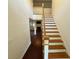 Bright entryway with wooden staircase and hardwood floors at 7832 Racquet Rd, North Charleston, SC 29418