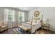 Bright bedroom with a post bed, ample natural light, and a tranquil atmosphere at 2215 Macallan Blvd, Ravenel, SC 29470