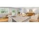 Kitchen island with granite countertop, sink, and seating for four at 2215 Macallan Blvd, Ravenel, SC 29470