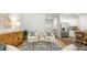 Bright living room with comfy seating, wood accent cabinet, and kitchen view at 2215 Macallan Blvd, Ravenel, SC 29470