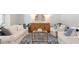 Relaxing living room with white sofas, blue rug, and wood accent cabinet at 2215 Macallan Blvd, Ravenel, SC 29470