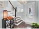 Spacious entryway with hardwood floors, staircase, and decorative accents at 211 Ilderton St, Summerville, SC 29483