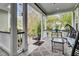 Covered back porch with wicker furniture and a view of the garden at 211 Ilderton St, Summerville, SC 29483