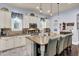 Updated kitchen boasts granite countertops, white cabinets, and an island with seating at 211 Ilderton St, Summerville, SC 29483