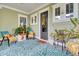 Cozy front porch features seating area and autumnal decorations at 211 Ilderton St, Summerville, SC 29483