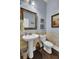 Charming bathroom with pedestal sink, toilet and decorative wall paneling at 211 Ilderton St, Summerville, SC 29483