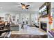 Open living room with fireplace, hardwood floors, and large windows at 211 Ilderton St, Summerville, SC 29483