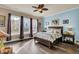 Bright bedroom featuring a king-size bed, hardwood floors, and large windows at 211 Ilderton St, Summerville, SC 29483