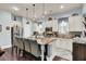 Modern kitchen with granite countertops, white cabinets, and stainless steel appliances at 211 Ilderton St, Summerville, SC 29483