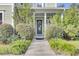 Inviting front porch with a gray door and lush landscaping at 211 Ilderton St, Summerville, SC 29483