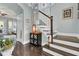 Elegant staircase with dark wood steps and white railings, leading to upper level at 211 Ilderton St, Summerville, SC 29483