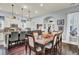 Bright dining room with a large table, hardwood floors, and adjacent kitchen access at 211 Ilderton St, Summerville, SC 29483