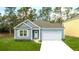 Charming one-story home with gray siding, white door and garage at 2215 Macallan Blvd, Ravenel, SC 29470