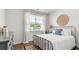 Spacious bedroom with a metal bed frame and large window at 2215 Macallan Blvd, Ravenel, SC 29470