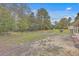 Large backyard with a fenced area and mature trees at 313 Fairlawn Dr, Moncks Corner, SC 29461