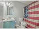 Bathroom with teal vanity, white toilet and American flag shower curtain at 313 Fairlawn Dr, Moncks Corner, SC 29461