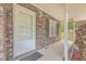 Front porch of brick house with white door and black shutters at 313 Fairlawn Dr, Moncks Corner, SC 29461