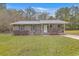 Brick ranch house with gray metal roof and small front porch at 313 Fairlawn Dr, Moncks Corner, SC 29461