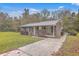 Brick ranch house with a metal roof, driveway, and landscaping at 313 Fairlawn Dr, Moncks Corner, SC 29461