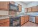 Kitchen with black appliances and wood cabinets at 313 Fairlawn Dr, Moncks Corner, SC 29461