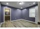 Spacious bedroom with neutral walls, wood-look flooring, and access to bathroom at 804 Chaplin St, Walterboro, SC 29488