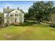 Stunning white two-story home with lush green lawn and large oak tree at 366 Avenue Of Oaks, Moncks Corner, SC 29461