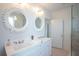 Bathroom with and sinks and large scallop mirrors at 9004 Topwater Ln, Johns Island, SC 29455