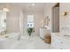 Elegant bathroom featuring a freestanding tub, marble tile, and modern vanity at 9004 Topwater Ln, Johns Island, SC 29455
