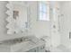 Modern bathroom with marble vanity, walk-in shower, and elegant mirror at 9004 Topwater Ln, Johns Island, SC 29455