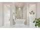 Luxury bathroom with a freestanding tub, a walk-in shower, and marble floors at 9004 Topwater Ln, Johns Island, SC 29455