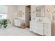 Spa-like bathroom with dual vanities, marble countertops, and a walk-in closet at 9004 Topwater Ln, Johns Island, SC 29455