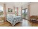 Charming bedroom with floral bedding, hardwood floors, and French doors leading to a balcony at 9004 Topwater Ln, Johns Island, SC 29455