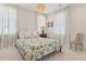 Serene bedroom with a green floral comforter and plenty of natural light at 9004 Topwater Ln, Johns Island, SC 29455